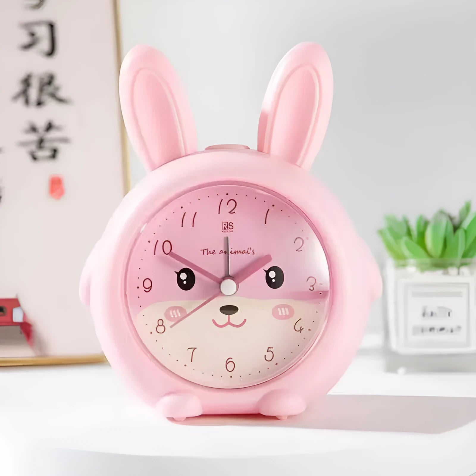 Cartoon children's alarm clock in pink or blue with night light and singing alarm.