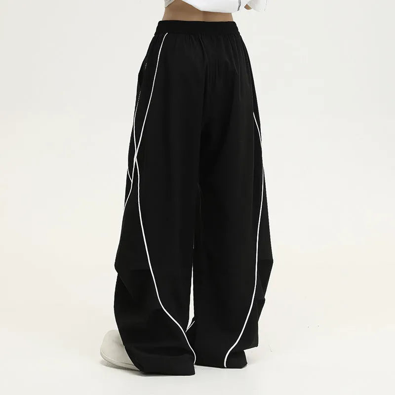 Black pleated wide-leg hip hop sports pants with stripe pattern laid flat