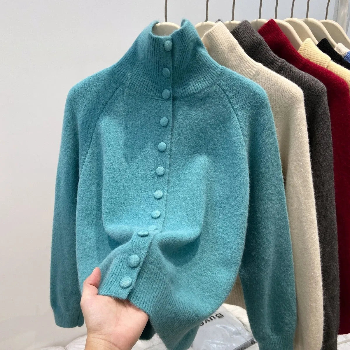 Women's loose fit turtleneck cardigan in thick polyester knit, button front, available in six colours including red and blue