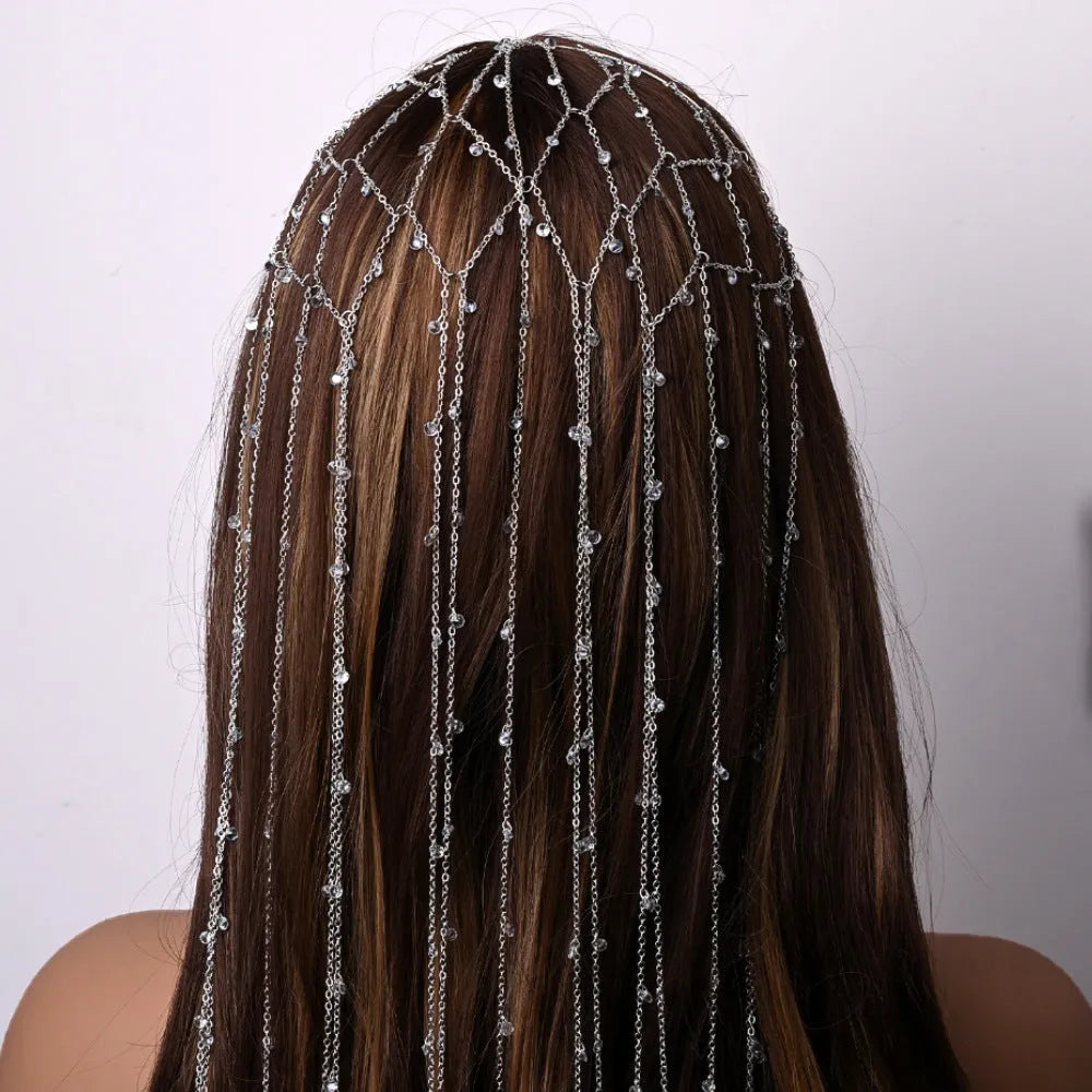 Gold and silver mesh headband with rhinestones and a decorative tassel on an adjustable band.