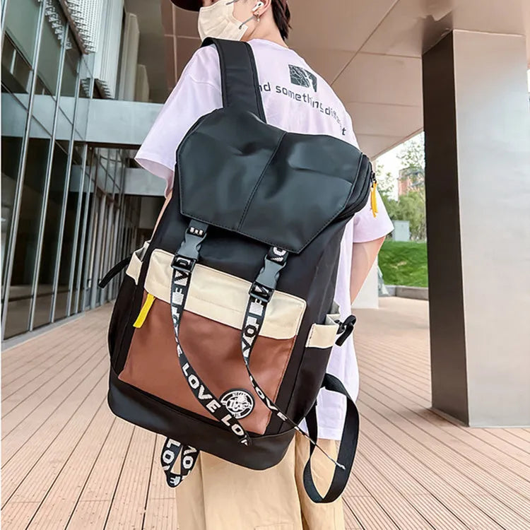 Oxford cloth backpack in black showing handheld strap and shoulder straps