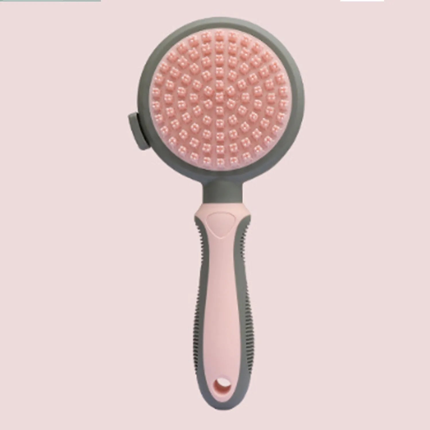 Green and pink double-sided cat grooming brush with slicker brush and flea comb, showing release button