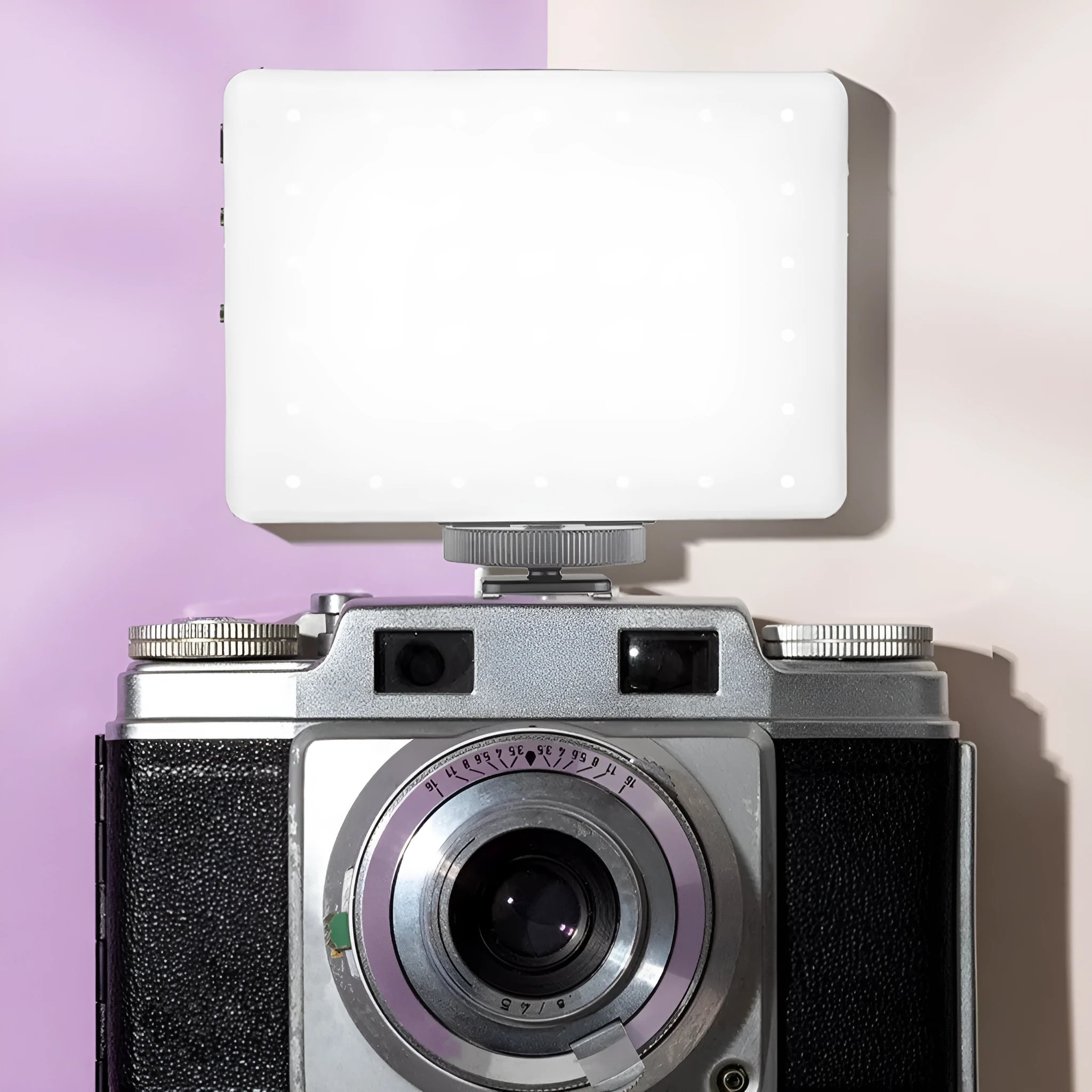 Pocket-sized clip-on LED fill light attached to a mobile phone for photography.