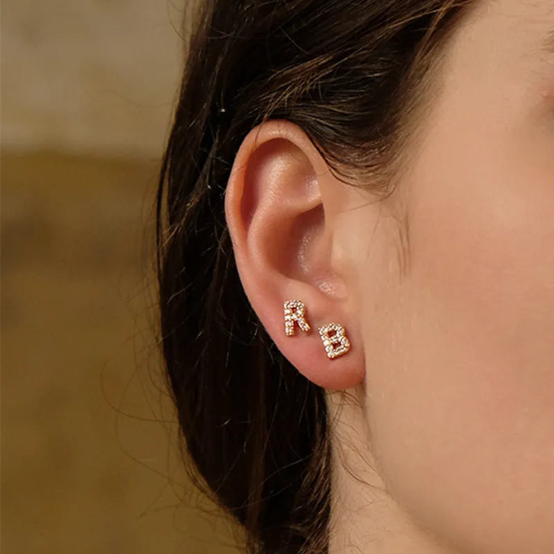 Gold plated alphabet letter earrings showing single English character with zircon decoration on brass base