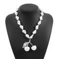 Women's adjustable pearl chain necklace with a geometric cherry fruit alloy pendant in gold colour.