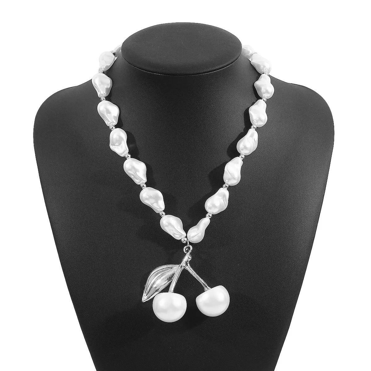 Women's adjustable pearl chain necklace with a geometric cherry fruit alloy pendant in gold colour.