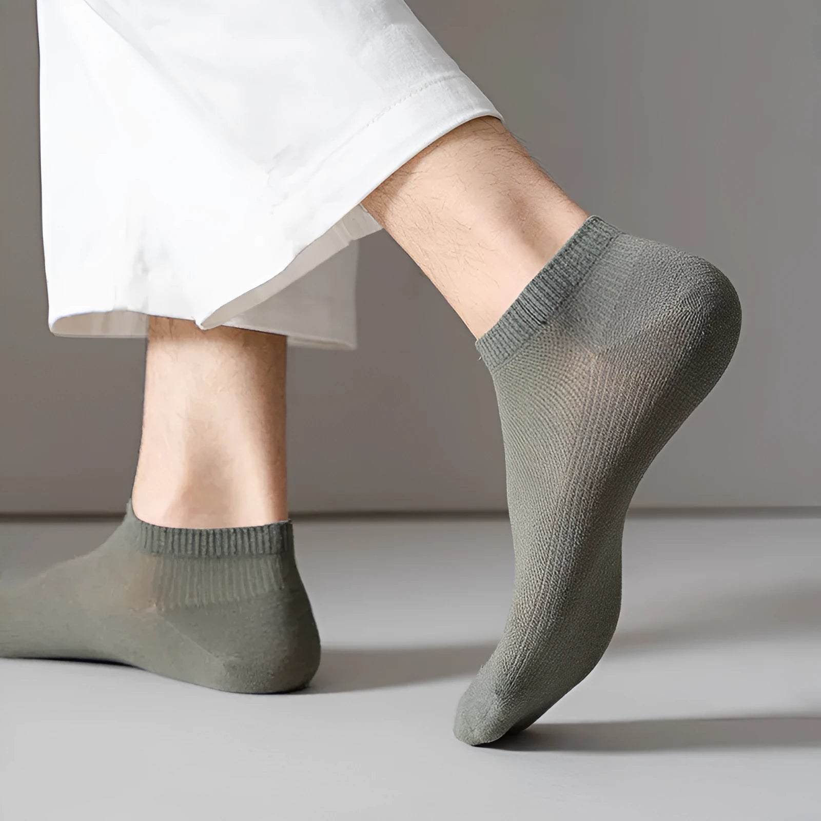 Pair of solid colour low-cut boat socks for men made from breathable polyester.