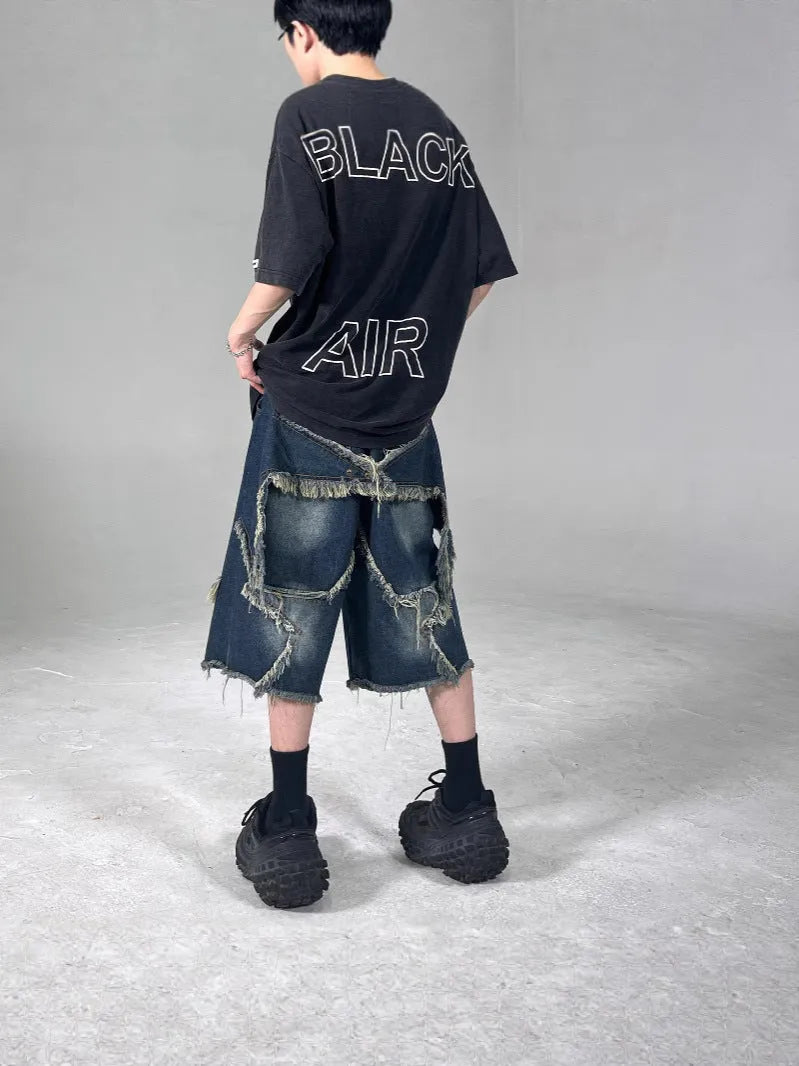 Blue men's denim shorts with frayed hem and five-pointed star patch in retro American style