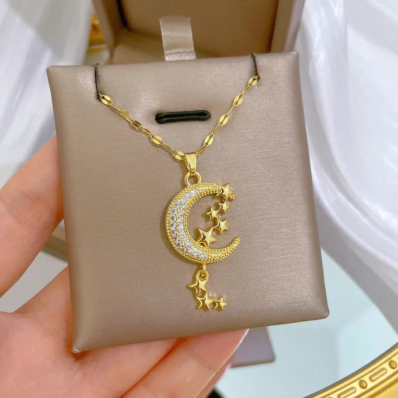 Geometric moon pendant necklace with tassel detailing and diamond accents on copper