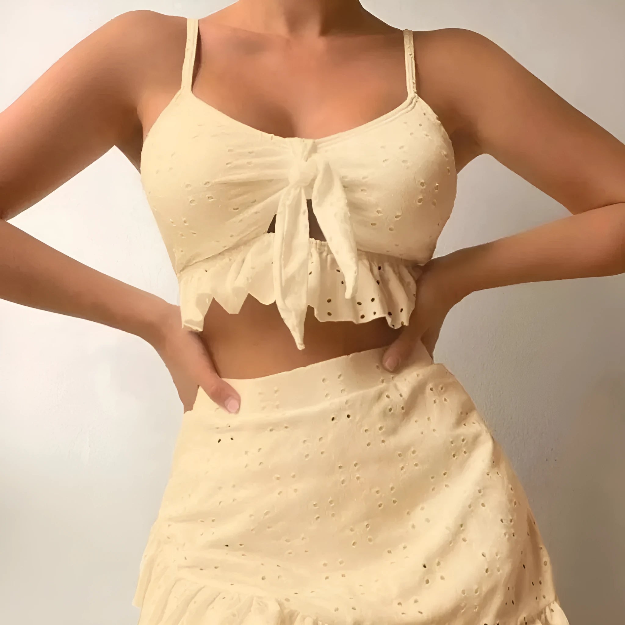 Women's solid colour three-piece swimsuit with bikini top, bottoms, and split hip skirt.