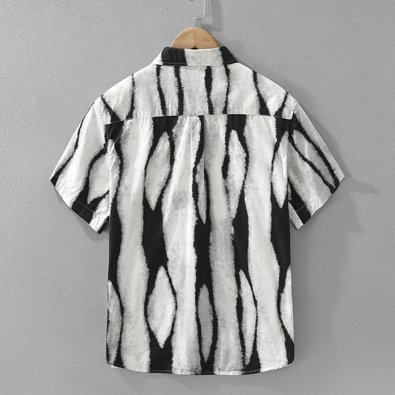 A retro-style black and white striped short sleeve shirt with a loose, cardigan fit.