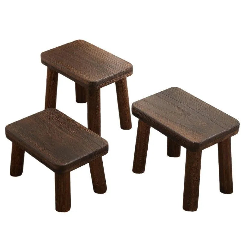 Solid wooden shoes changing stool with a distressed finish and bracket leg structure.