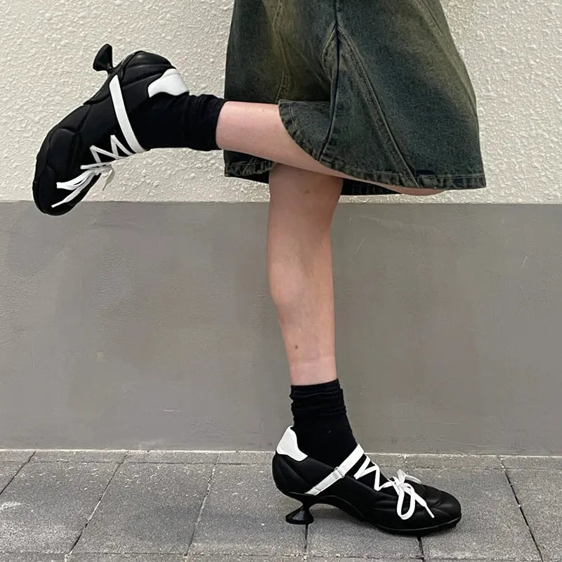 Women's silver lace-up bow sports shoes with a round toe and mid heel on a white background.