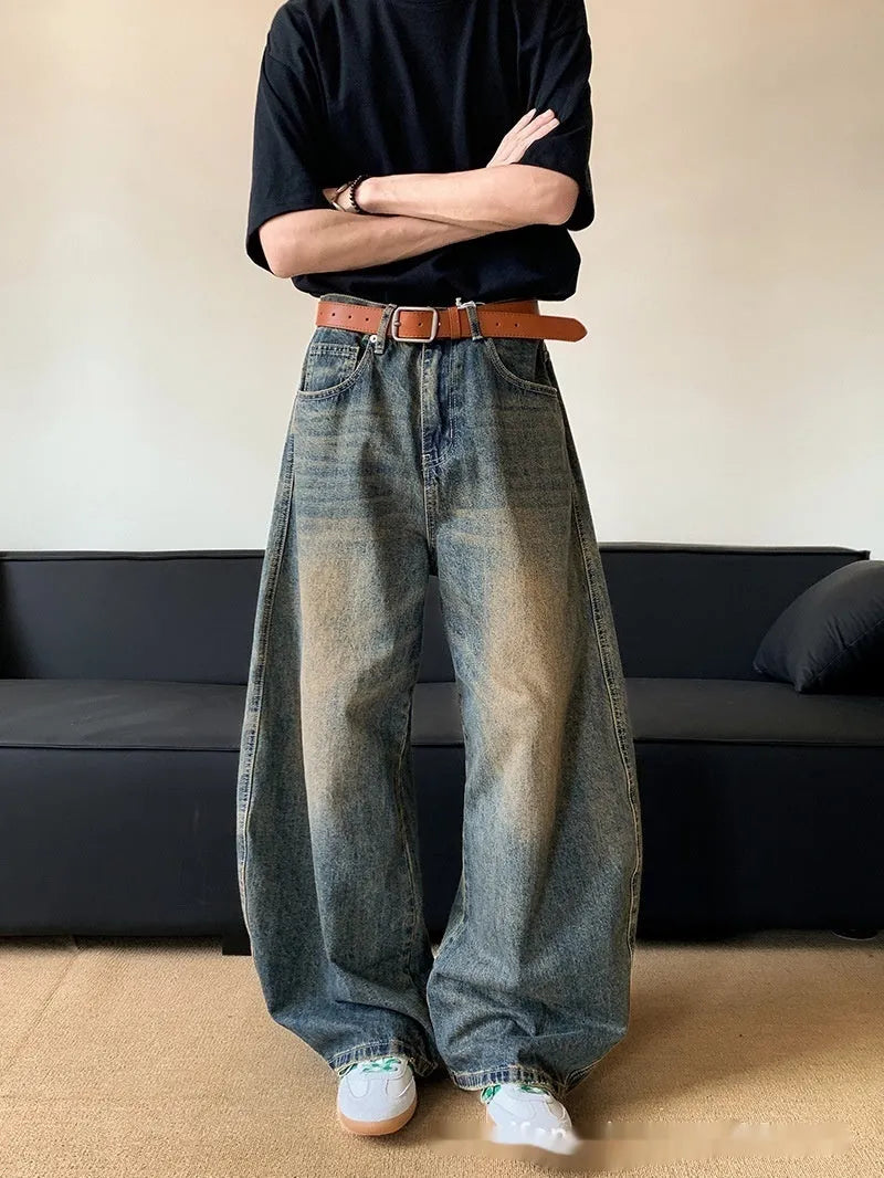Men's retro blue distressed denim jeans with a wide-leg slim fit and micro elasticity.