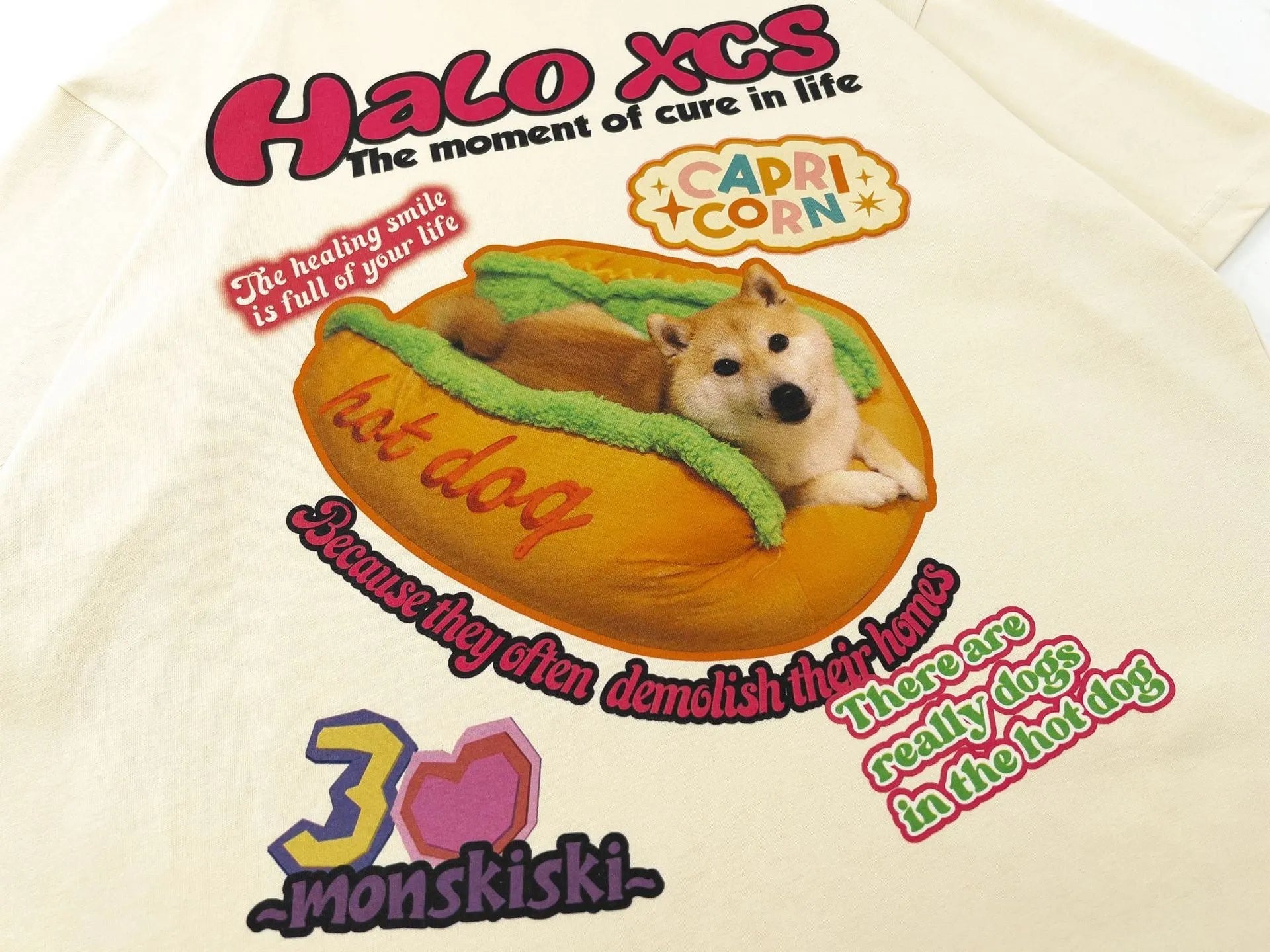 Cartoon hamburger dog printed cotton T-shirt in loose fit, shown in apricot colour.