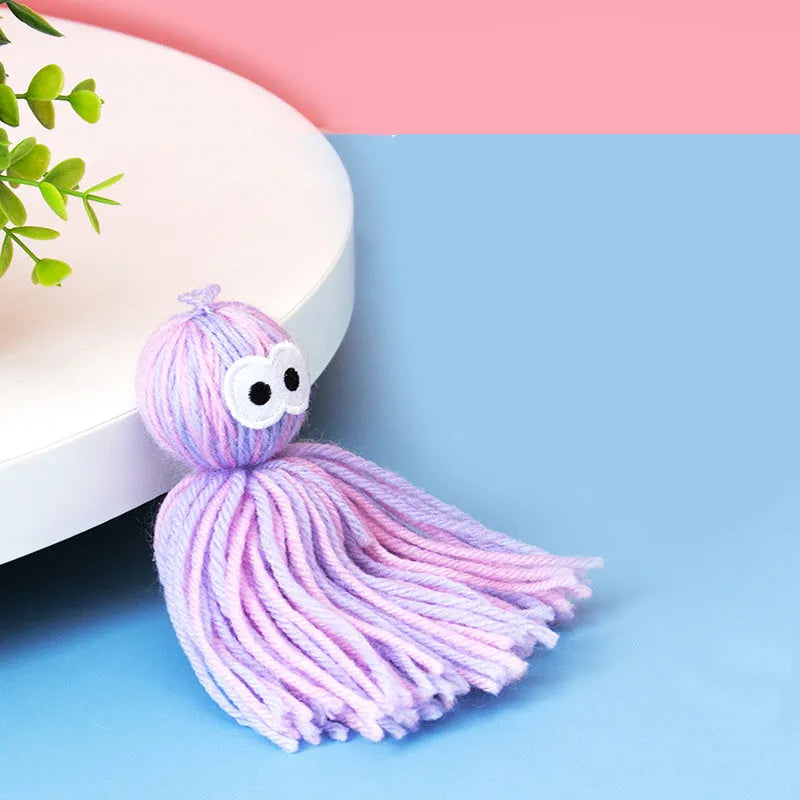 Wool ball cat toy with hanging loop in blue grey, pink and blue, and pink purple colour options