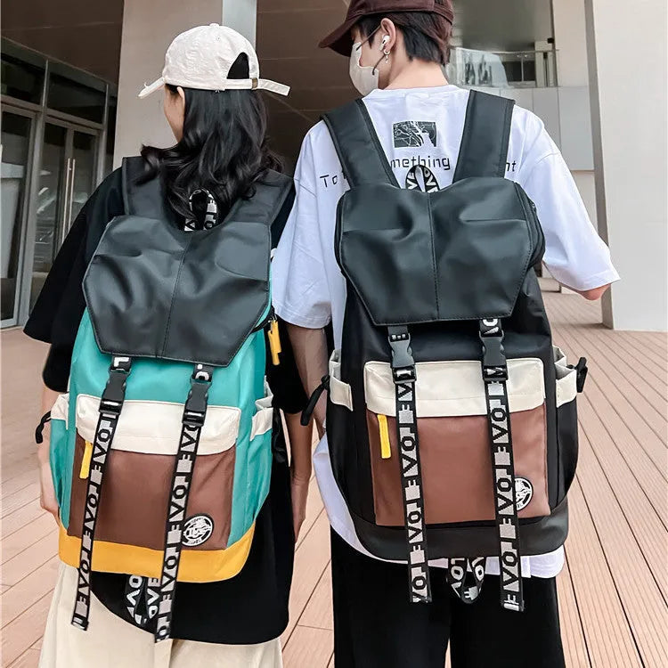 Oxford cloth backpack in black showing handheld strap and shoulder straps