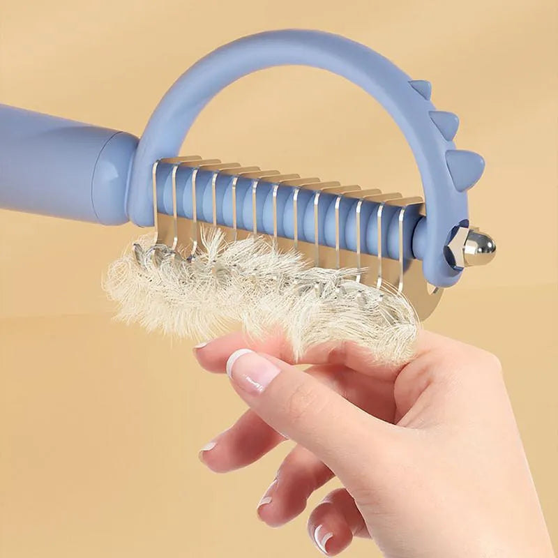 Self-cleaning cat brush with dinosaur shape and stainless steel pins for grooming