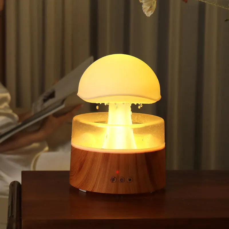 White cloud-shaped ultrasonic humidifier and aroma diffuser with simulated rain drops and coloured light.
