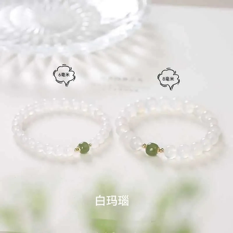 Handmade white agate crystal bracelet with cinnabar inlay showing 6mm and 8mm bead size options