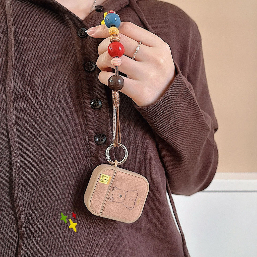 Brown dog magnetic TPU earphone sleeves for AirPods cases showing all-in-one design with lanyard clip
