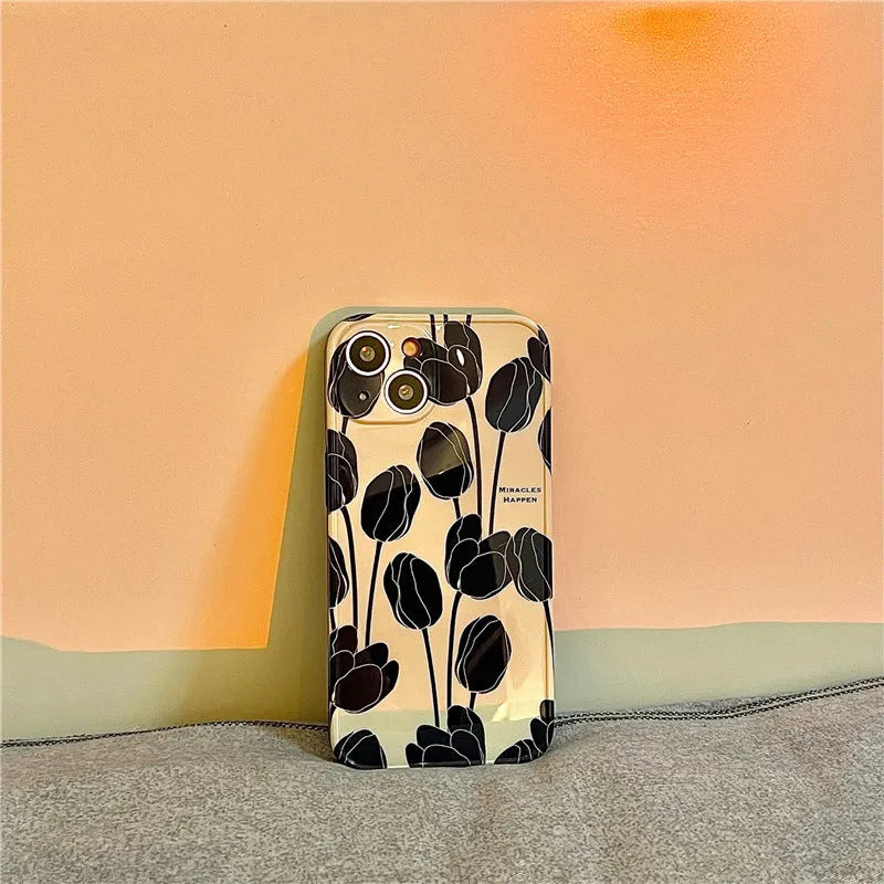 Black silicone iPhone case with a tulip flower design on the back.