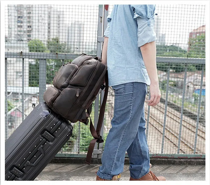 Dark brown retro crazy horse leather backpack for a 17-inch laptop, showing double shoulder straps and external pockets.