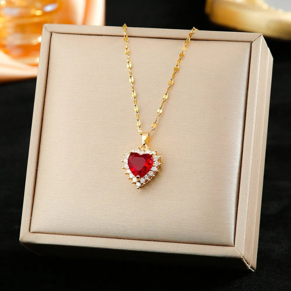 Gold red titanium steel jewellery suit with heart and flower pendant necklace, matching ear studs, and ring.