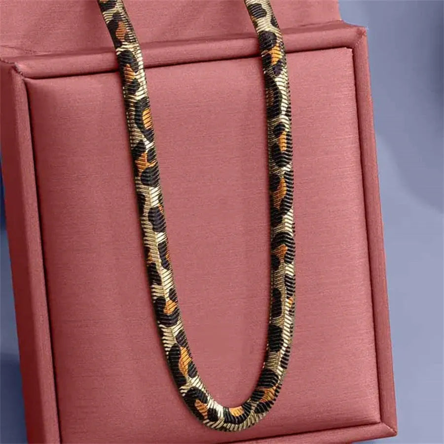 Women's alloy leopard necklace with leopard print motif against a neutral background