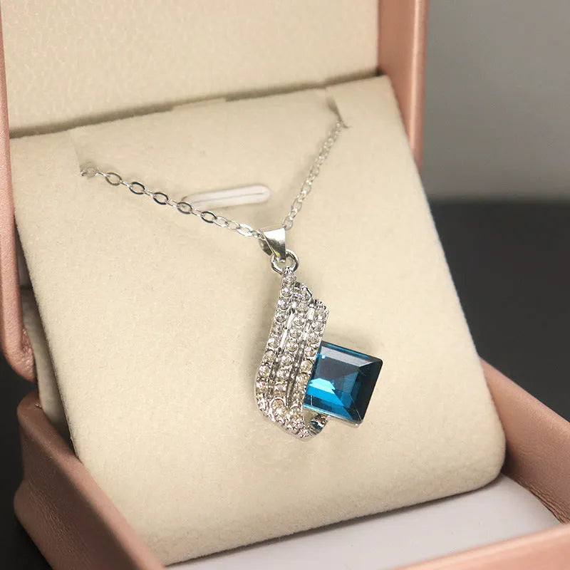 Women's electroplated necklace and earring set with cross chain design and glass pendant