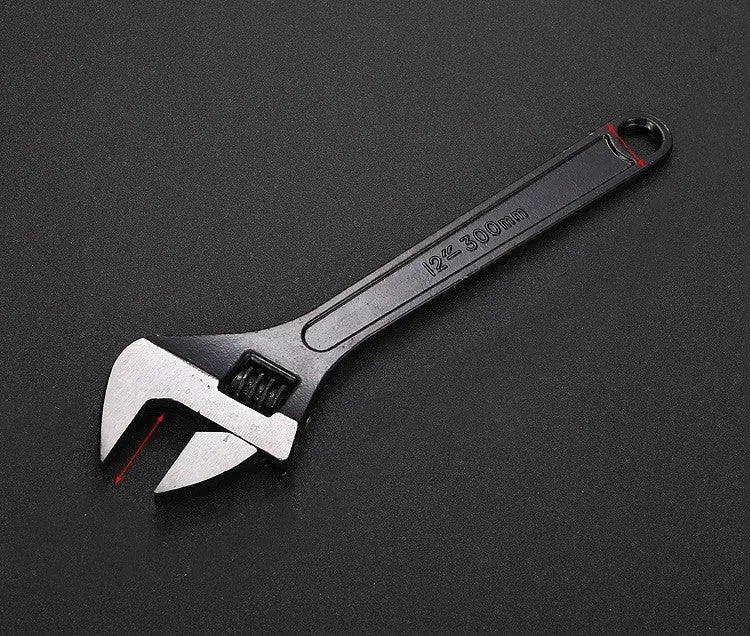 Stainless steel adjustable open-end wrench on a workbench
