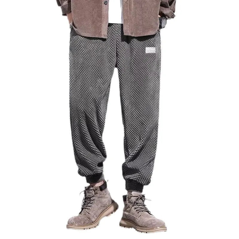 Men's grey straight-leg casual sweatpants with ankle strap detail on a hanger.