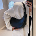 Women's retro-style PU shoulder bag in a dumpling shape, shown in cream yellow colour with a shoulder strap.