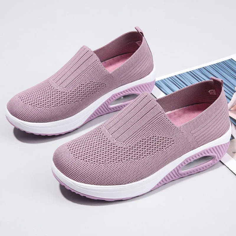 Women's black mesh running shoes with air cushion midsole and round toe on a grey background.