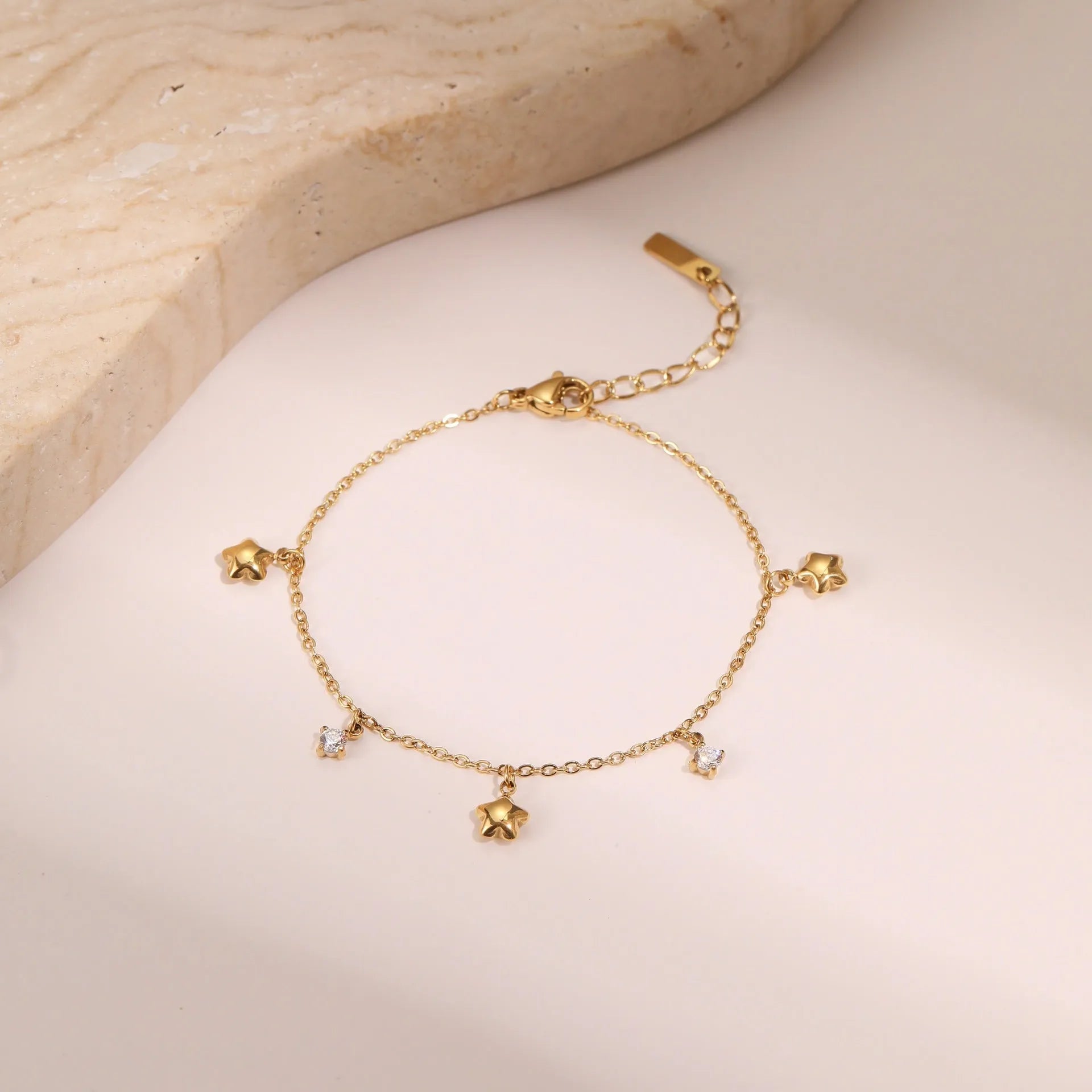 Gold plated star pendant bracelet on stainless steel chain with geometric hexagonal design