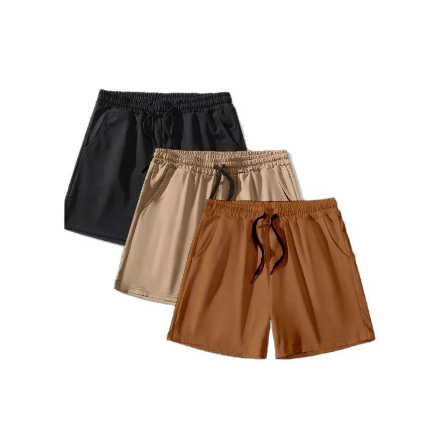 Men's black, khaki, and light brown drawstring casual shorts laid flat, showing loose fit and elasticated waistband.