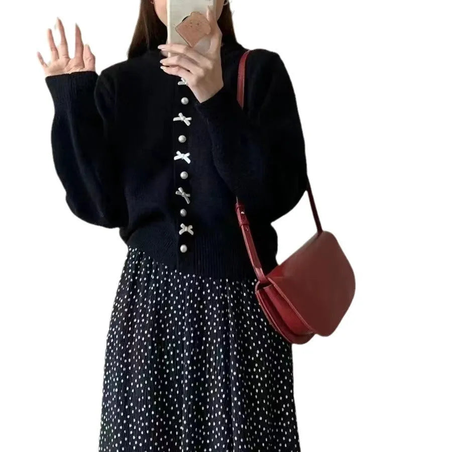 Women's solid colour cardigan with a bow and pearl buttons, shown in a light colour.