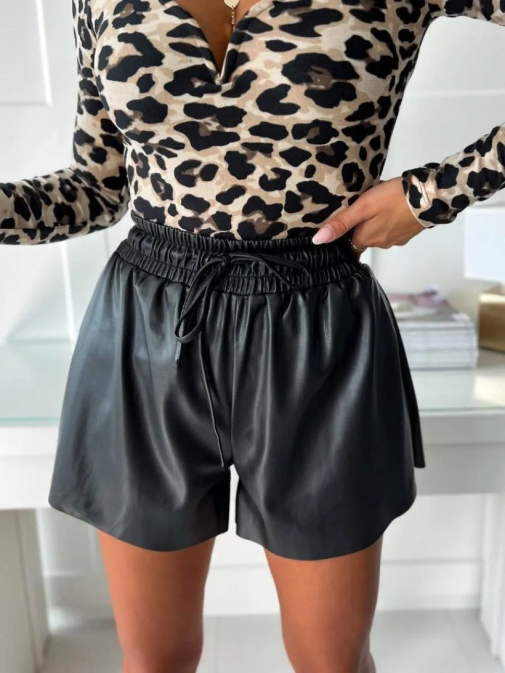 Women's black drawstring lace shorts with wide-leg casual styling and PU leather waist detail