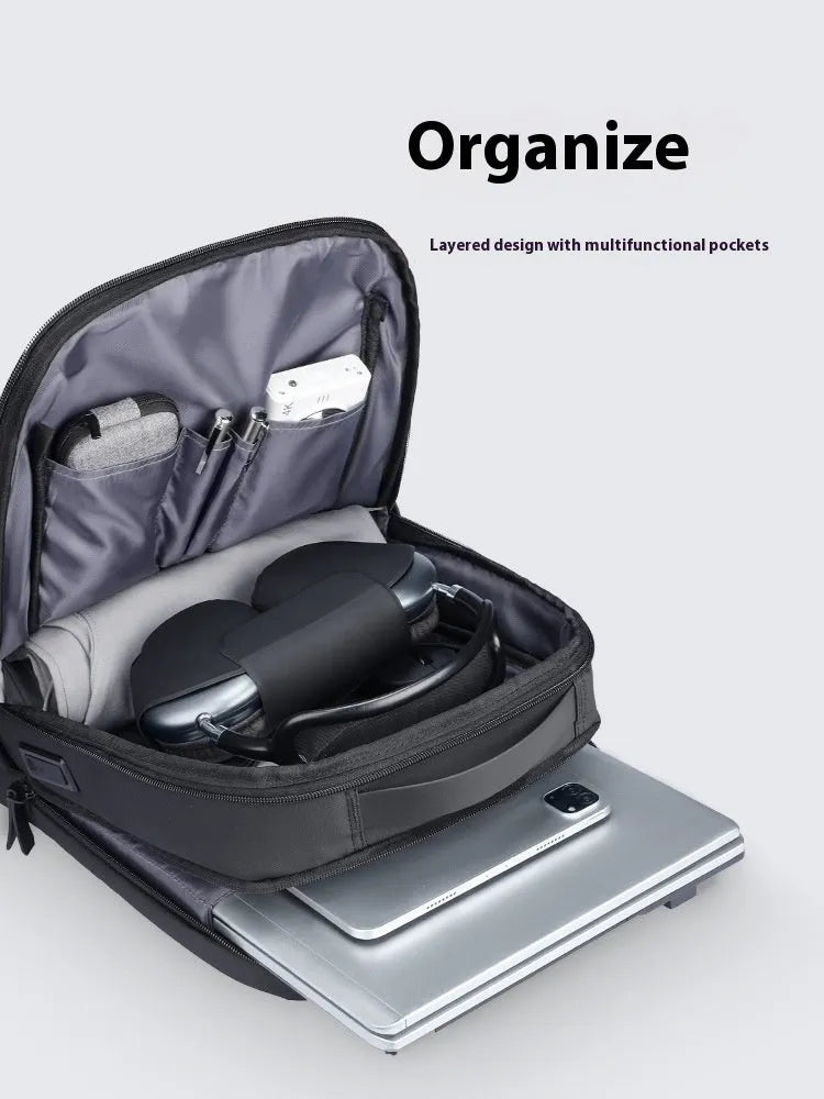 Graphite grey Oxford cloth business backpack with a USB charging port on the exterior.
