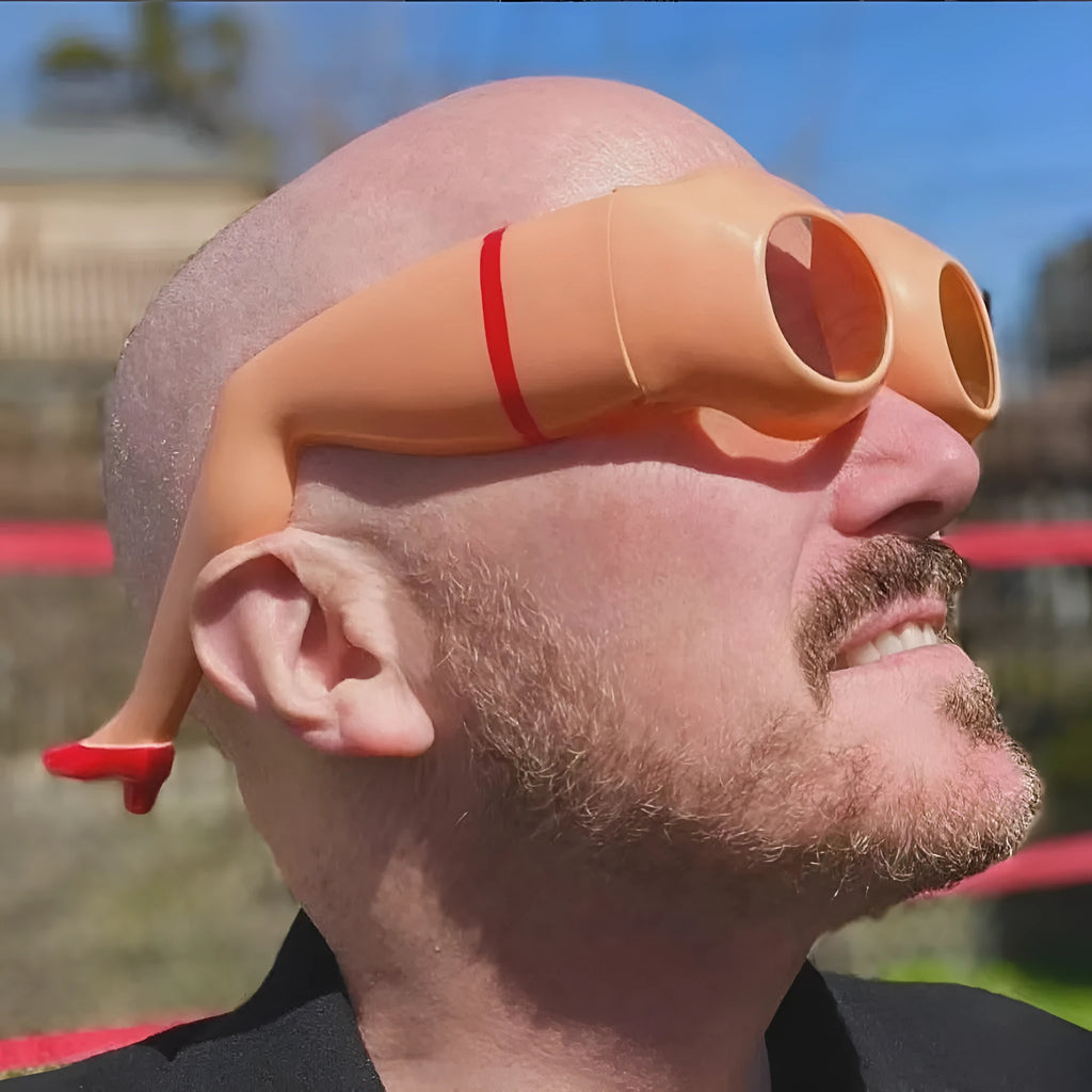 Orange plastic sunglasses with a novel leg and hip personality design on the frame.
