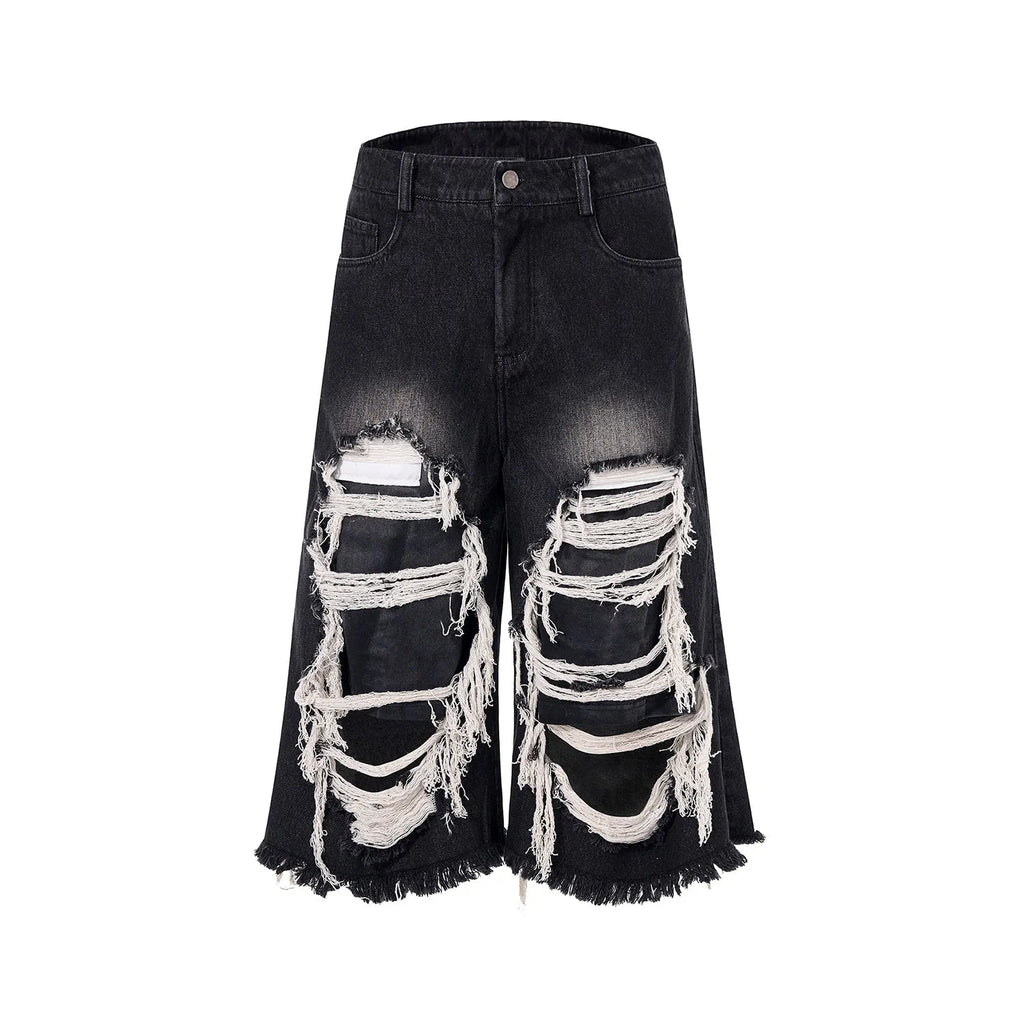 Women's black cropped wide leg jeans with ripped patch details and mid-high waist