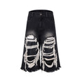 Women's black cropped wide leg jeans with ripped patch details and mid-high waist