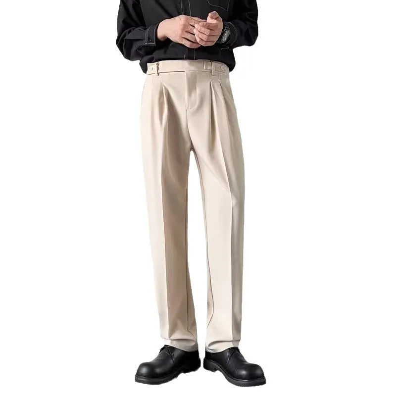 Men's straight loose fit suit trousers in apricot colour, laid flat.