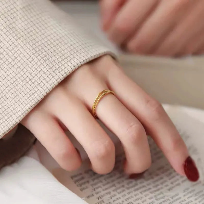 Women's brass gold plated ring shown in simple bracelet and twist ring styles.