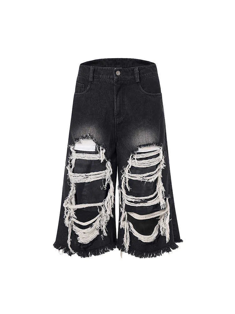 Women's black cropped wide leg jeans with ripped patch details and mid-high waist