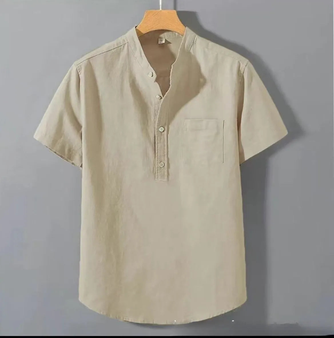 Men's loose-fit solid colour linen shirt with a stand collar and short sleeves on a hanger.