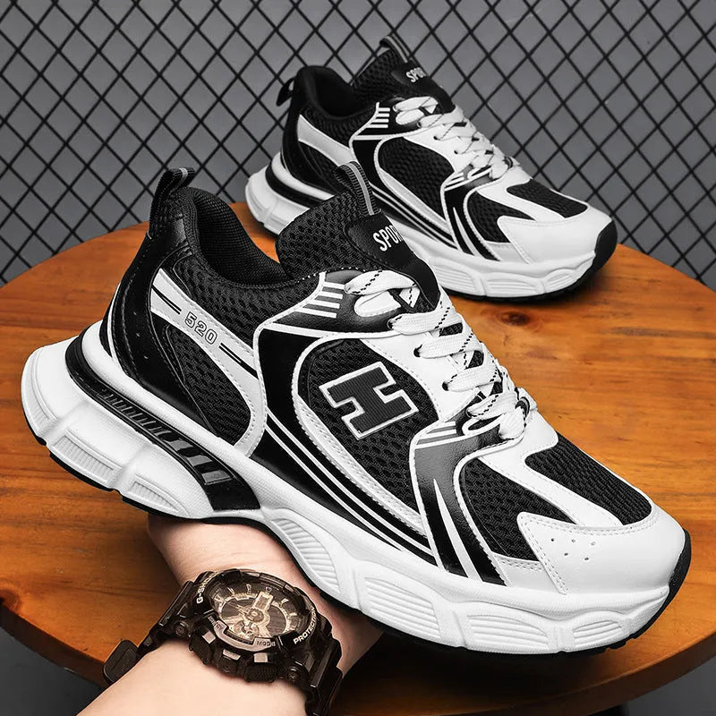 Men's black and white mesh casual running shoes with a round toe and plastic sole.