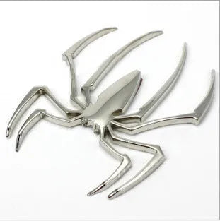 Three-dimensional metal spider car bumper sticker in zinc alloy, shown in gold colour.