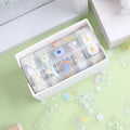 Five rolls of transparent adhesive tape with colourful daisy decoration on clear PET polyester backing