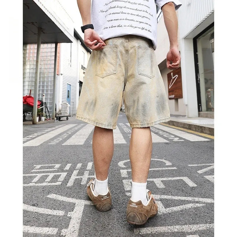 Men's light blue washed denim shorts with ripped details and a straight-leg cut